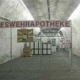 Ein großes Zimmer mit einem Schild, auf dem steht: "Bundeswehrrapotheke"