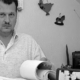 Ein Mann hält ein aufgerolltes Papier.